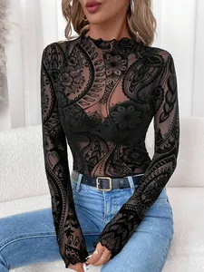 Detailed view of women's black mesh top with paisley flocking and lettuce edge trim