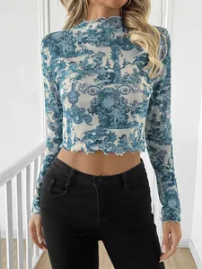 Stylish blue toile print mesh long sleeve crop top with ruffled mock neck and sheer finish.