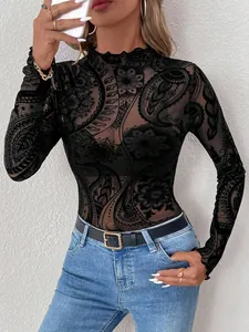 Close-up detail of the intricate black paisley flocked pattern on sheer mesh top