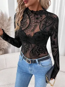 Detailed view of women's black mesh top with paisley flocking and lettuce edge