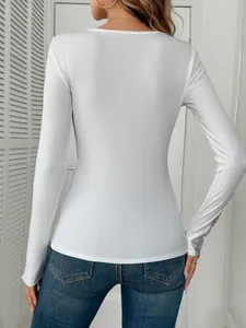 Back view detail of a white ribbed long sleeve top with lace and rhinestone cuffs