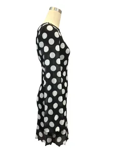 Detailed side view of a black mesh polka dot mini dress featuring stylish flare sleeves