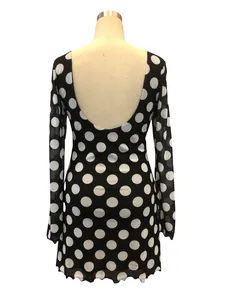 Back view of a sexy polka dot mesh mini dress featuring a deep U-shaped open back