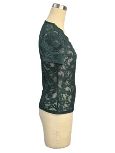 Detailed side view of dark green floral lace texture on a short-sleeved slim-fit top.