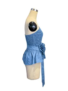 Side view of French style blue tube top featuring smocked bodice and 3D flower detail.