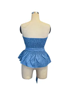 Back view of blue smocked strapless peplum top showing intricate denim texture details