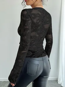 Detail view showing the intricate floral lace texture on a black slim fit long sleeve top