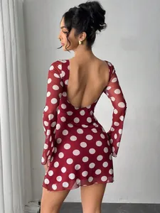 Sexy red polka dot mesh mini dress with deep open back and flared sleeves.