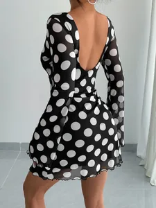 Detailed back view of a sexy polka dot backless mesh mini dress with elegant flare sleeves.