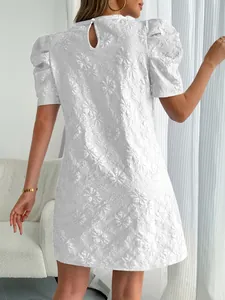 Detail back view of a white puff sleeve jacquard dress with elegant floral patterns
