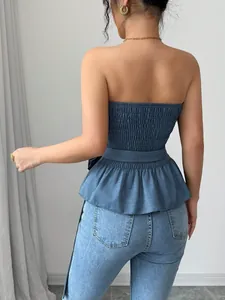Detailed back view of a blue smocked strapless tube top with a ruffled peplum hem
