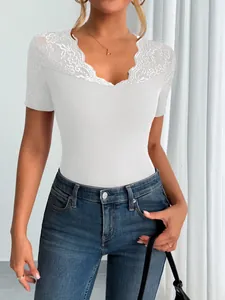 Detailed view of white short-sleeved top with elegant lace neckline and ribbed fabric