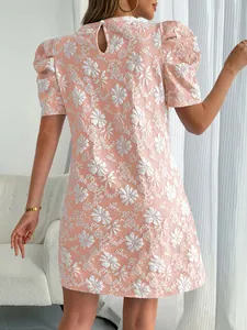 Back view of a pink puff sleeve dress featuring a vintage floral textured jacquard pattern.