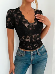 Detail of black lace slim-fit short sleeve V-neck top with scalloped edges for women
