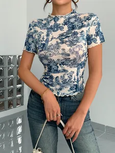 Detail of women's elegant mesh top with vintage blue toile print and lettuce trim