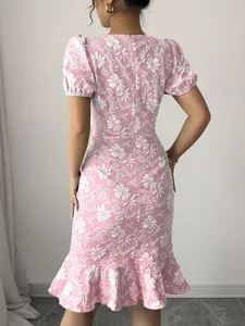 Back view of pink floral jacquard midi dress with puff sleeves and ruffled hem.