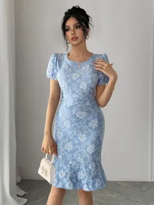 Close-up detail of a light blue floral bodycon dress with puff sleeves and mermaid hem