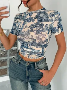 Close-up of elegant blue and white mesh print top with lettuce edge and mock neck detail