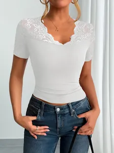 Elegant white short sleeve top featuring intricate lace trim on the V-neckline and cuffs