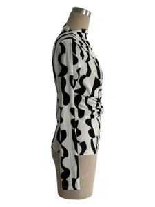 Detailed side view of black and white wavy print high-neck top with side pleats