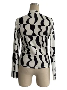 Back view of a long-sleeve slim fit women's top with black and white wavy pattern