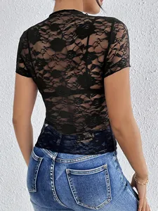 Back view of woman wearing black floral lace mock neck slim T-shirt with denim jeans