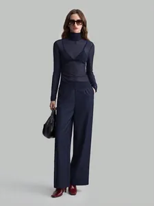 Navy blue sheer mesh turtleneck top paired with wide-leg trousers for a chic outfit