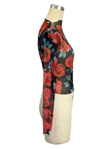 Side view detail of women's transparent mesh top with vibrant red rose flower prints