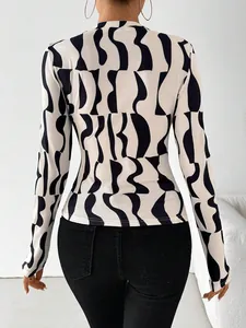 Elegant slim-fit long sleeve top with bold black and white wavy abstract print for women
