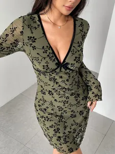 Close-up of olive green mesh dress with flocked floral pattern and V-neck