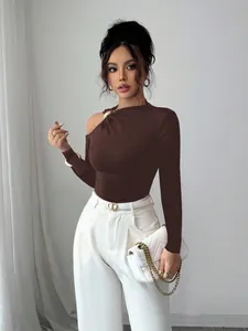 Close-up of slim-fit asymmetrical one-shoulder brown top with decorative metal hardware