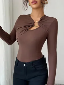 Detailed view of brown slim fit top with asymmetrical hollow neckline and gold ring