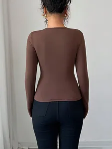 Detailed back view of a slim-fit brown long-sleeved top for women in minimalist style