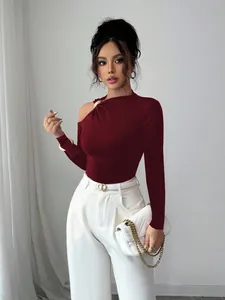 Detailed view of burgundy slim fit top with asymmetrical shoulder and metal ring ornament.
