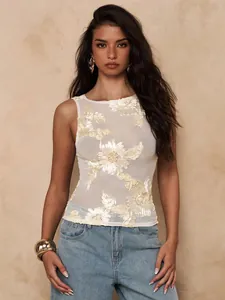 Detail view of sheer mesh sleeveless top with heavy floral embroidery and slim fit