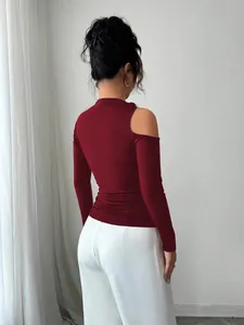 Back view of burgundy cold-shoulder long sleeve top with asymmetric neck design