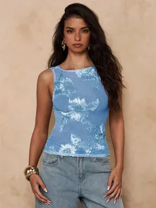 Detail view of a sheer blue mesh tank top featuring heavy 3D handcrafted floral embroidery.