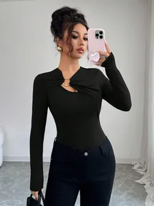 Stylish black long-sleeve slim fit top featuring an asymmetric cutout with metal ring detail