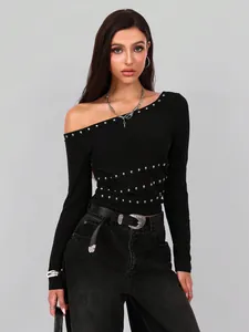 Detailweergave van een zwart slim-fit off-shoulder T-shirt met zilveren metalen studs.