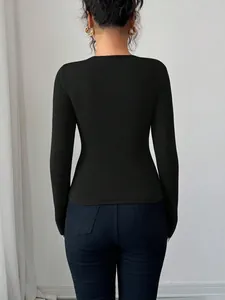 Back view of a minimalist slim-fit black long-sleeve top for modern women's fashion.