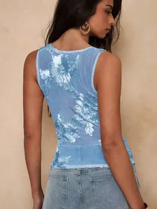 Detail of blue mesh tank top featuring intricate 3D floral embroidery on the back