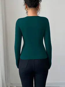 Professional back view of a slim fit dark green long sleeve women's casual autumn top