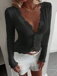 Detailed view of women's black long sleeve ribbed cardigan with delicate lace V-neck