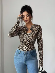 Detail of leopard print slim fit top with asymmetrical hollow metal ring decoration