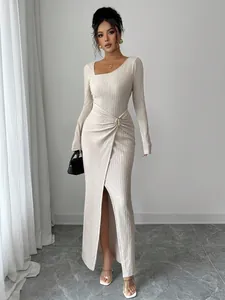 Long-sleeved knit maxi dress with irregular neckline and gathered waist detail