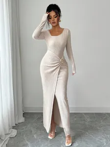 Detail view of long-sleeved knit maxi dress with textured fabric and gold buckle detail