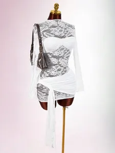Close-up of a white lace bodycon dress with elegant ruched details and a sash