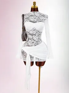 Close-up detail of a white lace patchwork mesh slim-fit pleated dress on a mannequin