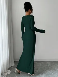 Back view of elegant deep green ribbed long sleeve maxi dress with a slim fit silhouette