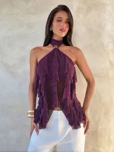 Close-up detail of a purple mesh halter top featuring tiered ruffles and gold neck buckle